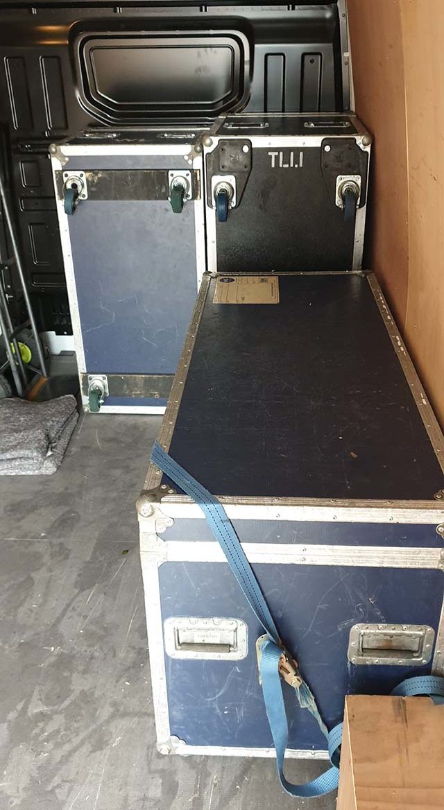 Photograph depicting flight cases secured in back of AB247 courier van