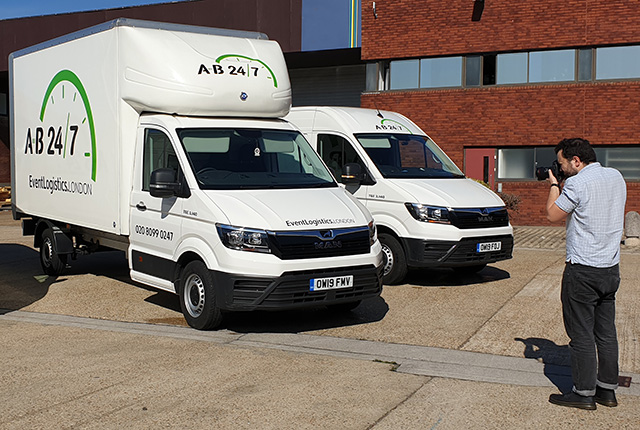 Photograph of photographer taking photos of event vans