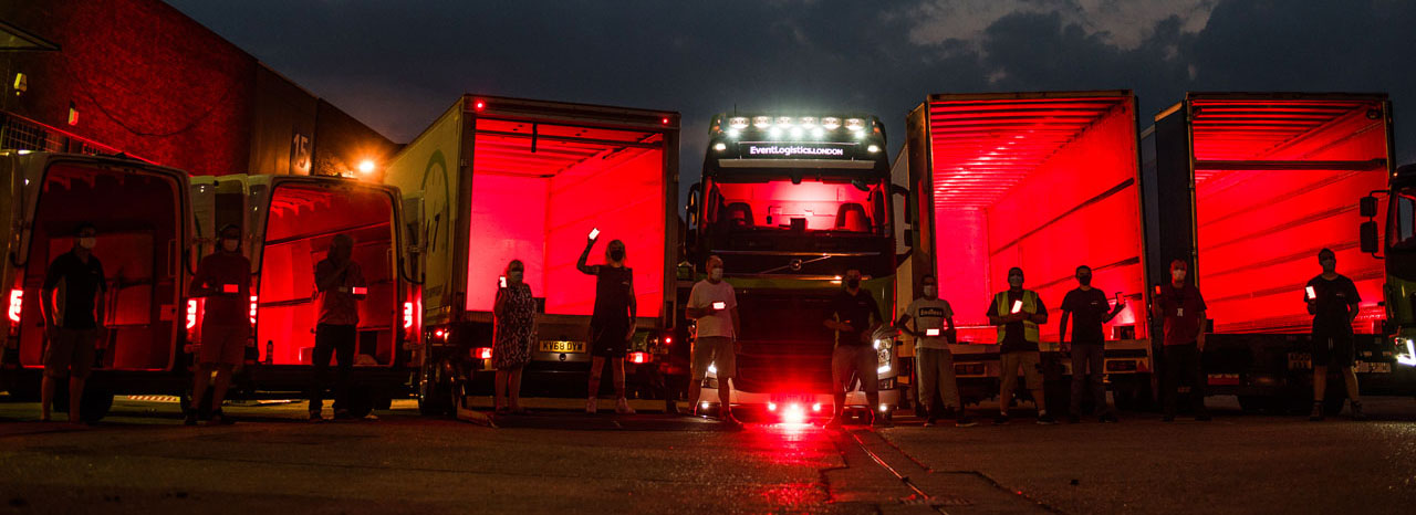 AB247 vehicles lit in red with staff