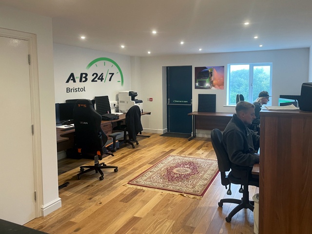 Photo taken of the inside of A-B 24/7 new depot in Bristol showing the office area with a couple of the event transport team hard at work.